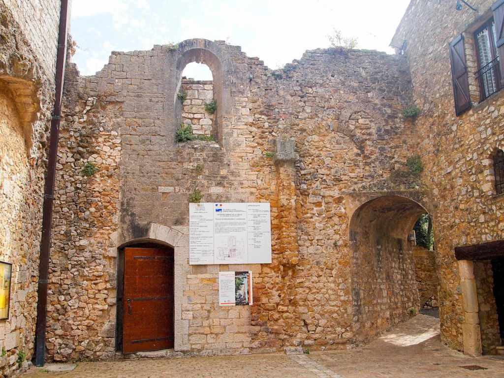 The original 11th-century church (église Sainte-Perpétue) is thought to have stood in the vacant space in the center;the 13th-century church and north gallery of the abbey are on the left; the monk's quarters are on the right (now a private residence); and the door on the right opens in front of the west gallery (in need of restoration). The thick walls of the passageway, which leads to the monk's cloister, are original. Photo: Pamela O'Neill
